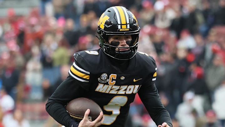 Nov 29, 2025; Fayetteville, Arkansas, USA; Missouri Tigers quarterback Beau Pribula (9) rushes during the first quarter against the Arkansas Razorbacks at Donald W. Reynolds Razorback Stadium. Mandatory Credit: Nelson Chenault-Imagn Images