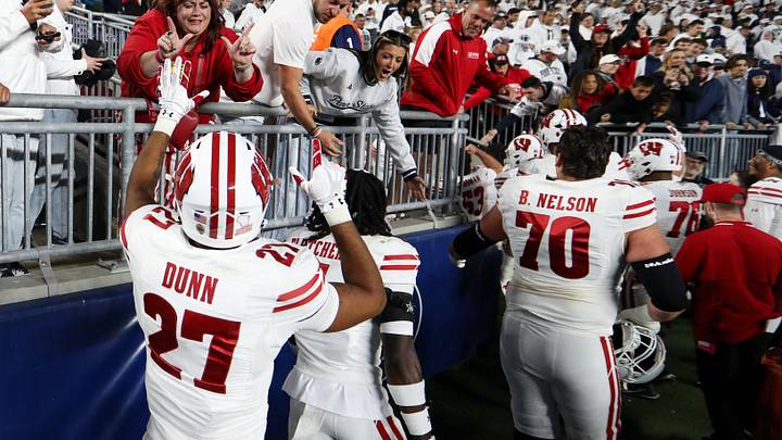 Wisconsin Badgers players celebrate with the fans following the game against the Penn State Nittany Lions at West Shore Home Field at Beaver Stadium.