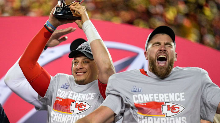 Kansas City Chiefs quarterback Patrick Mahomes (15) raises the Lamar Hunt Trophy with tight end