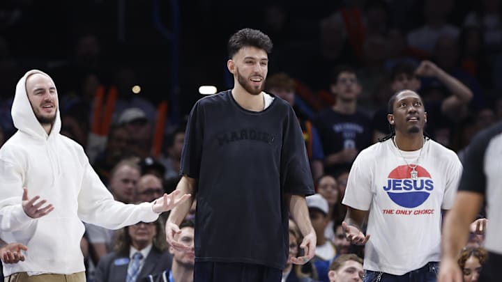 Feb 3, 2025; Oklahoma City, Oklahoma, USA; Oklahoma City Thunder guard Alex Caruso (9), forward Chet Holmgren (7), and forward Jalen Williams (8) watch their team play against the Milwaukee Bucks during the second half at Paycom Center. Mandatory Credit: Alonzo Adams-Imagn Images