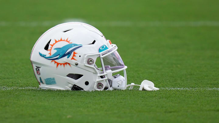 Aug 3, 2022; Miami Gardens, Florida, US; A general view of a Miami Dolphins helmet on the field during training camp at Baptist Health Training Complex. Mandatory Credit: Jasen Vinlove-Imagn Images Aug 3, 2022; Miami Gardens, Florida, US; A general view of a Miami Dolphins helmet on the field during training camp at Baptist Health Training Complex. Mandatory Credit: Jasen Vinlove-Imagn Images