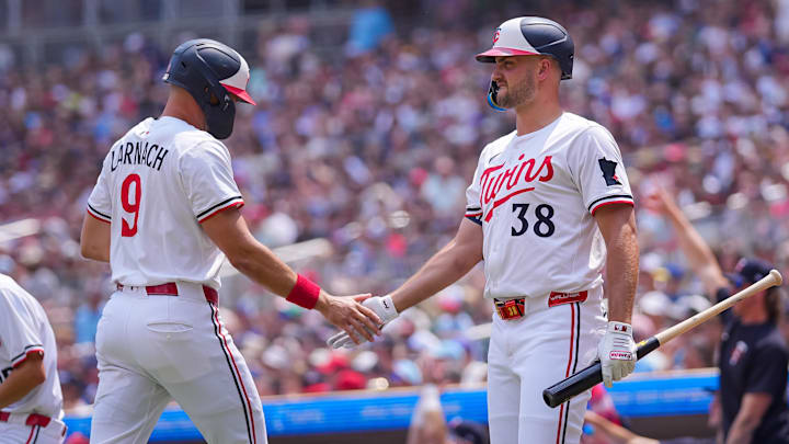 Jul 12, 2025; Minneapolis, Minnesota, USA; Minnesota Twins outfielder Trevor Larnach (9) celebrates his run with designated hitter Matt Wallner (38) against the Pittsburgh Pirates in the second inning at Target Field.
