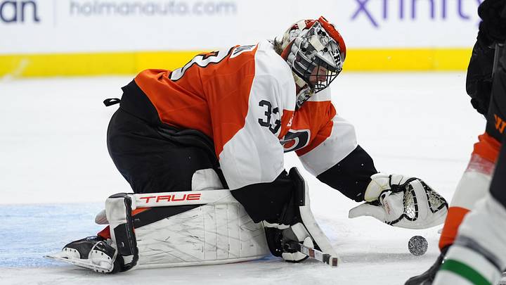 Mar 29, 2026; Philadelphia, Pennsylvania, USA; Philadelphia Flyers goalie Samuel Ersson (33) covers the puck against the Dallas Stars in the third period at Xfinity Mobile Arena. Mandatory Credit: Kyle Ross-Imagn Images