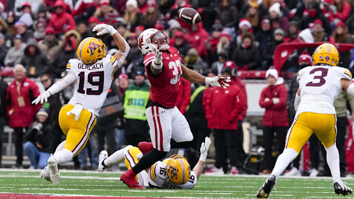 Nov 29, 2024; Madison, Wisconsin, USA;  Wisconsin Badgers tight end Riley Nowakowski (37) reaches for the pass tipped by Minnesota Golden Gophers linebacker Joey Gerlach (19) during the second quarter at Camp Randall Stadium. 