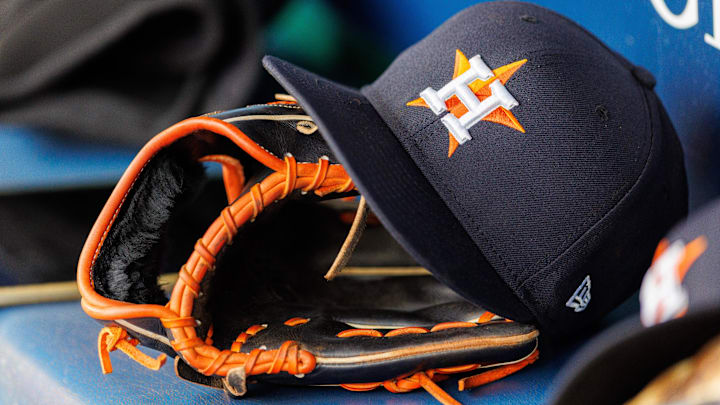 Apr 27, 2025; Kansas City, Missouri, USA; Houston Astros hat and glove in the dugout during the second inning against the Kansas City Royals at Kauffman Stadium. 