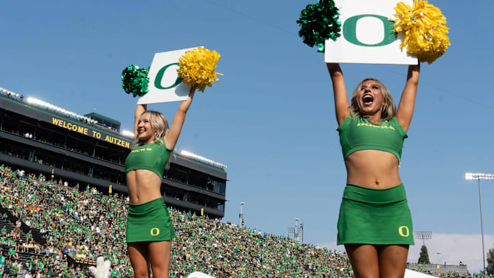 Oregon cheerleaders lead fans in a cheer during the Duck’s game against Oklahoma State at Autzen.