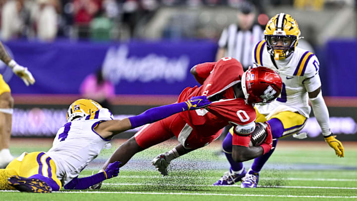 Dec 27, 2025; Houston, TX, USA; Louisiana State Tigers cornerback DJ Pickett (3) tackles Houston Cougars wide receiver Amare Thomas (0) during the second half at NRG Stadium. 