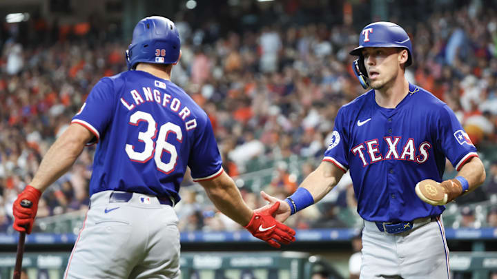 Apr 13, 2024; Houston, Texas, USA; Texas Rangers designated hitter Wyatt Langford (36) celebrates left fielder Evan Carter (32) run on third baseman Josh Smith (8) RBI single against the Houston Astros in the first inning at Minute Maid Park.