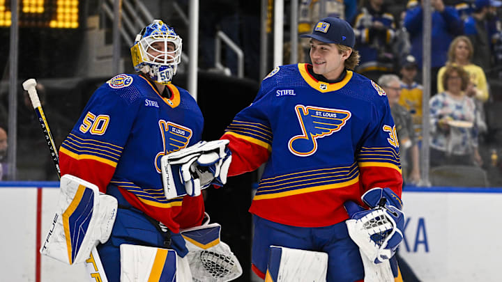 Mar 13, 2024; St. Louis, Missouri, USA;  St. Louis Blues goaltender Jordan Binnington (50) celebrates with goaltender Joel Hofer (30) after the Blues defeated the Los Angeles Kings at Enterprise Center. Mandatory Credit: Jeff Curry-Imagn Images