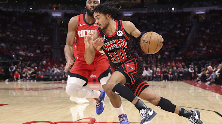 Jan 13, 2026; Houston, Texas, USA; Chicago Bulls guard Tre Jones (30) attempts to drive with the ball around Houston Rockets guard Josh Okogie (20) during the first quarter at Toyota Center. Mandatory Credit: Troy Taormina-Imagn Images