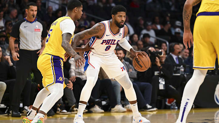 Nov 8, 2024; Los Angeles, California, USA; Philadelphia 76ers forward Paul George (8) dribbles against Los Angeles Lakers forward Cam Reddish (5) during the first half at Crypto.com Arena. Mandatory Credit: Jonathan Hui-Imagn Images