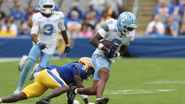 Oct 10, 2026; Pittsburgh, Pennsylvania, USA;  North Carolina Tar Heels defensive back Tre Miller (6) returns an interception against Pittsburgh Panthers running back Justin Cook (5) during the third quarter at Acrisure Stadium.  Mandatory Credit: Charles LeClaire-Imagn Images