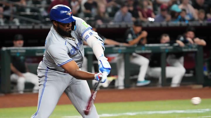 Jul 12, 2024; Phoenix, Arizona, USA; Toronto Blue Jays first base Vladimir Guerrero Jr. (27) hits a single against the Arizona Diamondbacks during the first inning at Chase Field. 