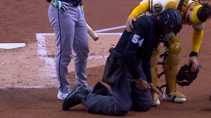 Umpire C.B. Bucknor took a foul ball to the mask and had to leave the Milwaukee Brewers-Tampa Bay Rays game on Wednesday.