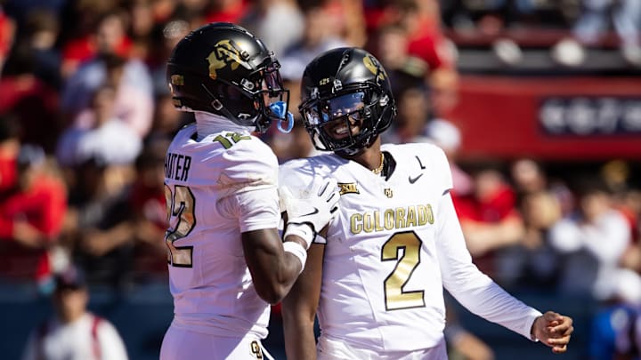 Oct 19, 2024; Tucson, Arizona, USA; Colorado Buffalos quarterback Shedeur Sanders (2) with wide receiver Travis Hunter (12) against the Arizona Wildcats at Arizona Stadium.