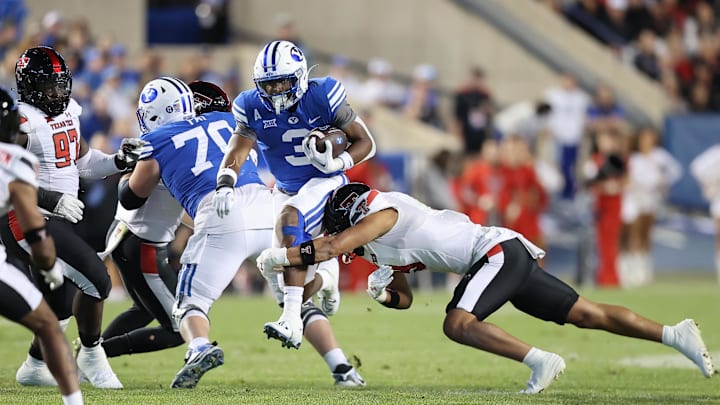 Oct 21, 2023; Provo, Utah, USA; Brigham Young Cougars running back Aidan Robbins (3) is tackled by Texas Tech Red Raiders linebacker Bryce Ramirez (3) in the second half at LaVell Edwards Stadium. Mandatory Credit: Rob Gray-Imagn Images