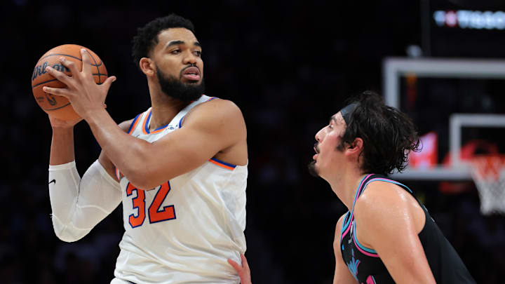 Nov 17, 2025; Miami, Florida, USA; New York Knicks center Karl-Anthony Towns (32) protects the basketball from Miami Heat forward Jaime Jaquez Jr. (11) during the fourth quarter at Kaseya Center. Mandatory Credit: Sam Navarro-Imagn Images