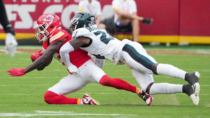 Sep 14, 2025; Kansas City, Missouri, USA; Philadelphia Eagles safety Andrew Mukuba (24) tackles Kansas City Chiefs wide receiver Hollywood Brown (5) during the third quarter of the game at GEHA Field at Arrowhead Stadium. Mandatory Credit: Denny Medley-Imagn Images