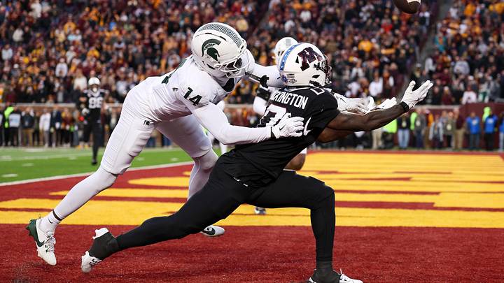 Nov 1, 2025; Minneapolis, Minnesota, USA; Michigan State Spartans defensive back Malcolm Bell (14) commits a pass interference penalty against Minnesota Golden Gophers wide receiver Lemeke Brockington (0) during overtime at Huntington Bank Stadium. Mandatory Credit: Matt Krohn-Imagn Images Nov 1, 2025; Minneapolis, Minnesota, USA; Michigan State Spartans defensive back Malcolm Bell (14) commits a pass interference penalty against Minnesota Golden Gophers wide receiver Lemeke Brockington (0) during overtime at Huntington Bank Stadium. Mandatory Credit: Matt Krohn-Imagn Images