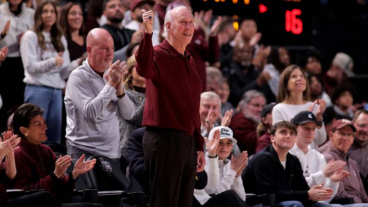 Jan 11, 2025; College Station, Texas, USA; Former Texas A&M Aggies football coach R.C. Slocum acknowledges the fans during a timeout against the Alabama Crimson Tide during the first half at Reed Arena. Mandatory Credit: Erik Williams-Imagn Images