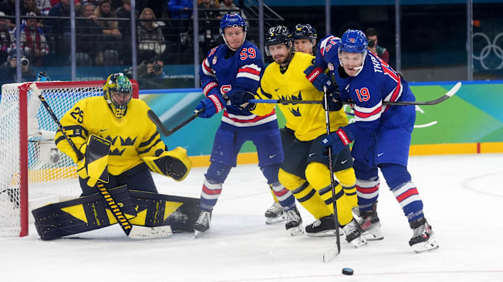 Feb 18, 2026; Milan, Italy;  Matthew Tkachuk of United States and Jake Guentzel of United States in action with Oliver Ekman-Larsson of Sweden and Gustav Forsling of Sweden  in a men's ice hockey quarterfinal during the Milano Cortina 2026 Olympic Winter Games at Milano Santagiulia Ice Hockey Arena. Mandatory Credit: Amber Searls-Imagn Images