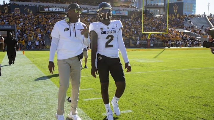 Oct 7, 2023; Tempe, Arizona, USA; Colorado Buffaloes head coach Deion Sanders with son and quarterback Shedeur Sanders (2) against the Arizona State Sun Devils at Mountain America Stadium. Oct 7, 2023; Tempe, Arizona, USA; Colorado Buffaloes head coach Deion Sanders with son and quarterback Shedeur Sanders (2) against the Arizona State Sun Devils at Mountain America Stadium.