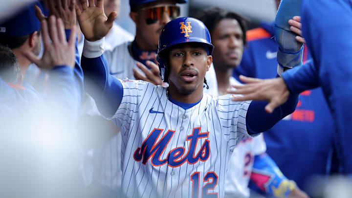 Apr 4, 2025; New York City, New York, USA; New York Mets shortstop Francisco Lindor (12) celebrates with teammates in the dugout after scoring on an RBI double by right fielder Juan Soto (not pictured) during the sixth inning against the Toronto Blue Jays at Citi Field. Mandatory Credit: Brad Penner-Imagn Images