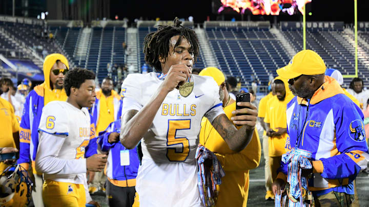Miami Northwestern's Calvin Russell Jr. takes a selfie with his state medal after his team won the Class 3A championship against Raines on Dec. 14, 2024.