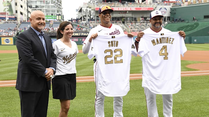 Jul 17, 2022; Washington, District of Columbia, USA;  Washington Nationals right fielder Juan Soto (22) and manager Dave Martinez (4) receive their All Star jerseys from general manager Mike Rizzo before the game against the Atlanta Braves at Nationals Park.