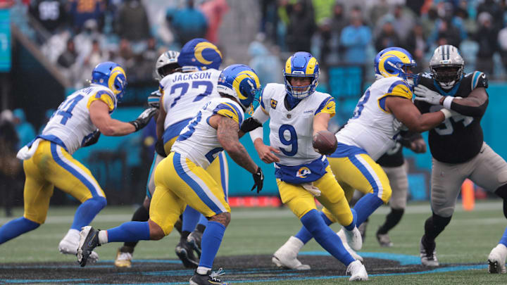 Nov 30, 2025; Charlotte, North Carolina, USA; Los Angeles Rams quarterback Matthew Stafford (9) hands the ball off to Los Angeles Rams running back Kyren Williams (23) during the fourth quarter against the Carolina Panthers at Bank of America Stadium. Mandatory Credit: Scott Kinser-Imagn Images