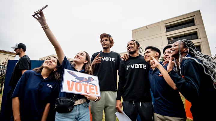 Oct 22, 2024, San Antonio, Texas, USA; San Antonio Spurs forward Jeremy Sochan (10) and point guard Tre Jones (33) pose for photos with representatives of UTSA after casting their votes in the 2024 Presidential Election.