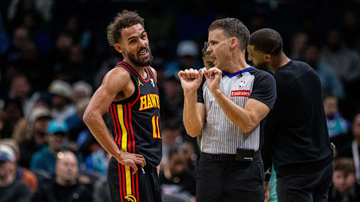 Nov 30, 2024; Charlotte, North Carolina, USA; Atlanta Hawks guard Trae Young (11) talks with an official during the second quarter against the Charlotte Hornets at Spectrum Center. Mandatory Credit: Scott Kinser-Imagn Images