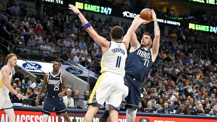Mar 22, 2023; Dallas, Texas, USA; Golden State Warriors guard Klay Thompson (11) and Dallas Mavericks guard Luka Doncic (77) in action during the game between the Dallas Mavericks and the Golden State Warriors at the American Airlines Center. Mandatory Credit: Jerome Miron-USA TODAY Sports