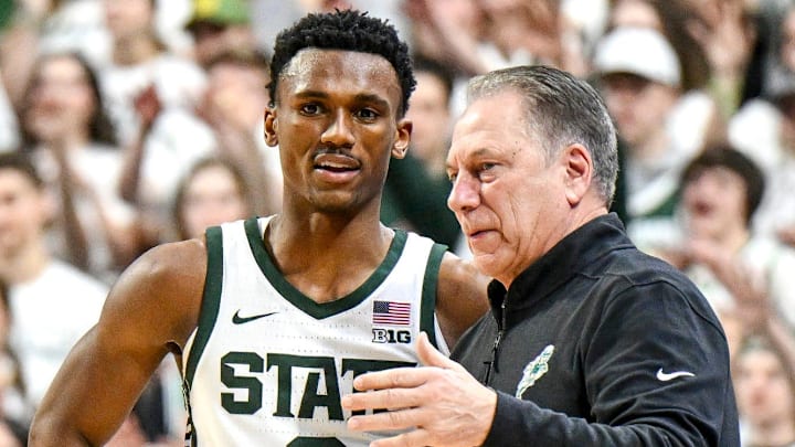 Michigan State's Tyson Walker, left, talks with head coach Tom Izzo during the first half in the