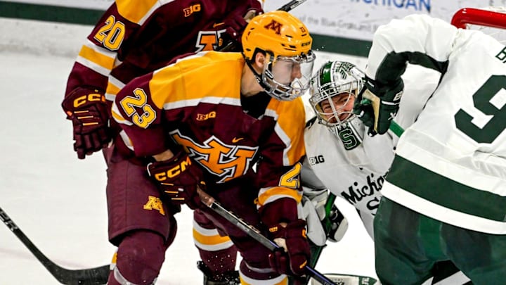 Michigan State's Trey Augustine, center, and Matt Basgall, right, fight off Minnesota's Jimmy Clark, left, and Luke Mittelstadt, far left battle at the goal during the second period on Saturday, Jan. 25, 2025, at Munn Arena in East Lansing. Mittelstadt scored on the play.