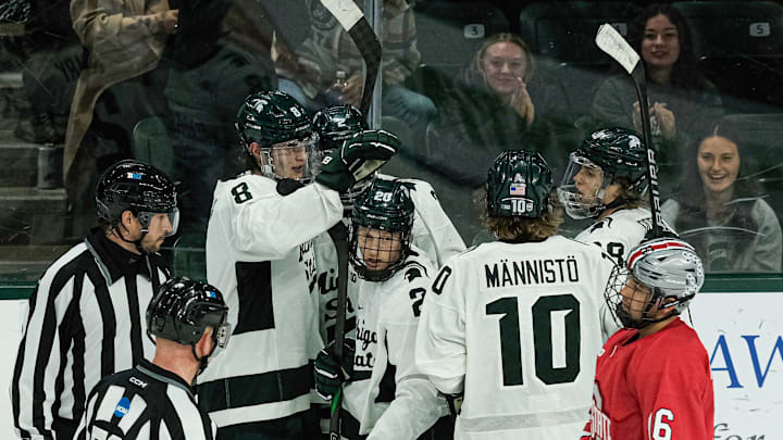 The Spartans celebrate Daniel Russell's (20) empty net goal to put them up 4-1 against the Buckeyes at Munn Arena Saturday, Nov. 9, 2024.