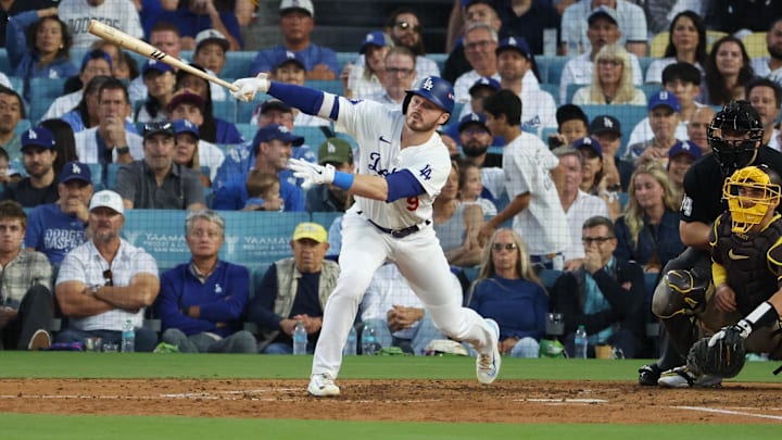 Oct 6, 2024; Los Angeles, California, USA; Los Angeles Dodgers second baseman Gavin Lux (9) hits a single in the fifth inning against the San Diego Padres during game two of the NLDS for the 2024 MLB Playoffs at Dodger Stadium.
