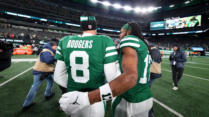 Jan 5, 2025; East Rutherford, New Jersey, USA; New York Jets quarterback Aaron Rodgers (8) and wide receiver Davante Adams (17) walk on the field after the Jets win over the Miami Dolphins at MetLife Stadium. Mandatory Credit: Ed Mulholland-Imagn Images