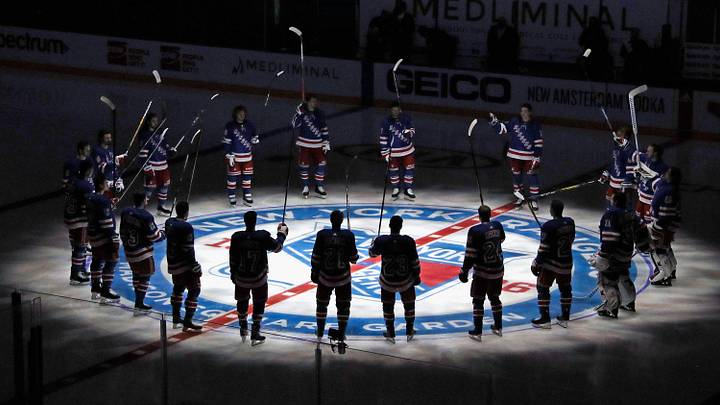 Jan 14, 2021; New York, NY, USA; New York Rangers players huddle around the center ice logo as they prepare for the home opener against the New York Islanders at Madison Square Garden. Jan 14, 2021; New York, NY, USA; New York Rangers players huddle around the center ice logo as they prepare for the home opener against the New York Islanders at Madison Square Garden.