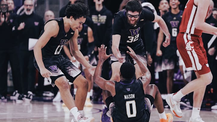 Huskies Jase Butler and Wilhelm Breidenbach rush to help up Mekhi Mason in a physical game with the WSU. 