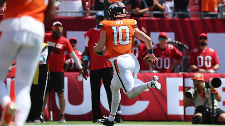 Sep 22, 2024; Tampa, Florida, USA; Denver Broncos quarterback Bo Nix (10) runs the ball in for a touchdown against the Tampa Bay Buccaneers during the first quarter at Raymond James Stadium. 