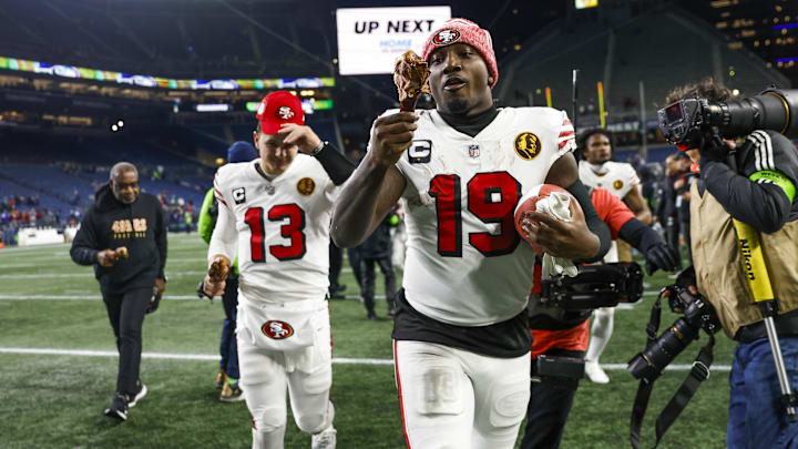 Nov 23, 2023; Seattle, Washington, USA; San Francisco 49ers wide receiver Deebo Samuel (19) eats a turkey leg as he and quarterback Brock Purdy (13) jog to the locker room following a 31-13 victory against the Seattle Seahawks at Lumen Field. Mandatory Credit: Joe Nicholson-Imagn Images