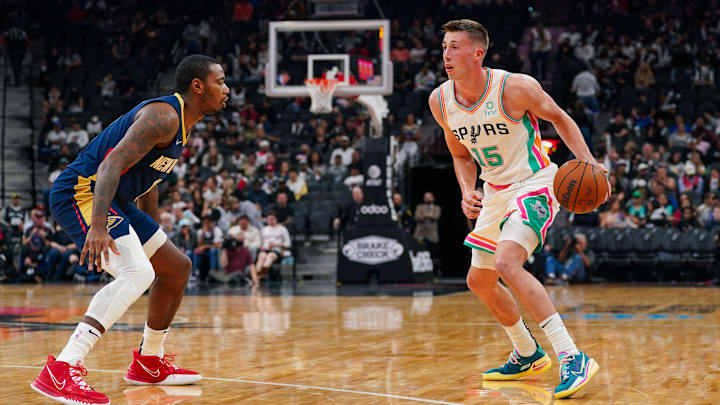 Mar 18, 2022; San Antonio, Texas, USA; San Antonio Spurs forward Joe Wieskamp (15) dribbles in front of New Orleans Pelicans forward Gary Clark (12) in the second half at the AT&T Center. Mandatory Credit: Daniel Dunn-Imagn Images