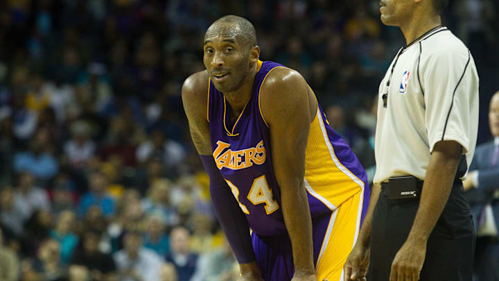 Dec 28, 2015; Charlotte, NC, USA; Los Angeles Lakers forward Kobe Bryant (24) talks with a referee after being called for a foul in the second half against the Charlotte Hornets at Time Warner Cable Arena. The Hornets won 108-98. Mandatory Credit: Jeremy Brevard-Imagn Images