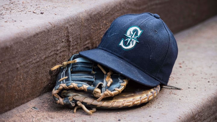 Aug 18, 2015; Arlington, TX, USA; A view of a Seattle Mariners ball cap and glove during the game between the Texas Rangers and the Seattle Mariners at Globe Life Park in Arlington. The Mariners defeat the Rangers 3-2. Mandatory Credit: Jerome Miron-Imagn Images