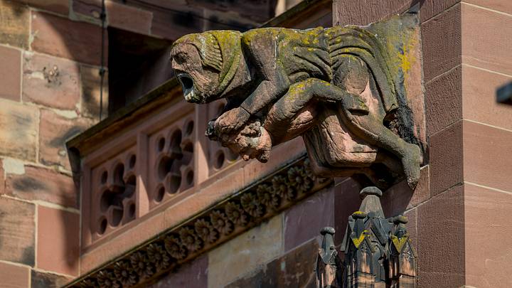 A medieval stone gargoyle on the exterior of Germany's Gothic Freiburg Minster. A medieval stone gargoyle on the exterior of Germany's Gothic Freiburg Minster.