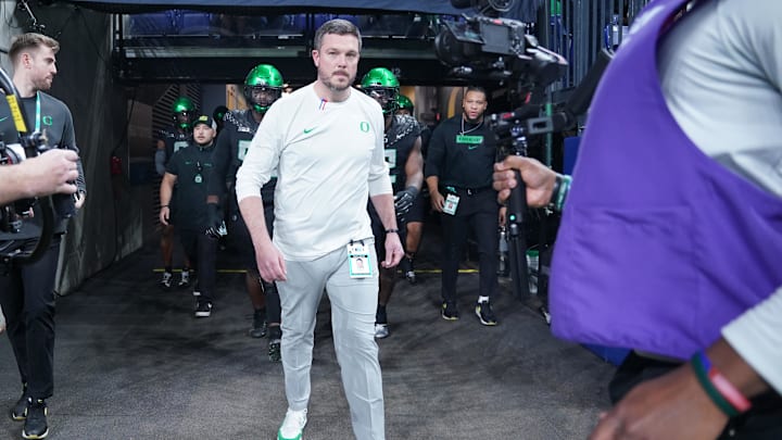 Dec 7, 2024; Indianapolis, IN, USA; Oregon Ducks head coach Dan Lanning runs out for warmups against the Penn State Nittany Lions in the 2024 Big Ten Championship game at Lucas Oil Stadium. Mandatory Credit: Robert Goddin-Imagn Images Dec 7, 2024; Indianapolis, IN, USA; Oregon Ducks head coach Dan Lanning runs out for warmups against the Penn State Nittany Lions in the 2024 Big Ten Championship game at Lucas Oil Stadium. Mandatory Credit: Robert Goddin-Imagn Images