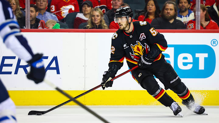 Oct 26, 2024; Calgary, Alberta, CAN; Calgary Flames defenseman MacKenzie Weegar (52) controls the puck against the Winnipeg Jets during the second period at Scotiabank Saddledome. Mandatory Credit: Sergei Belski-Imagn Images