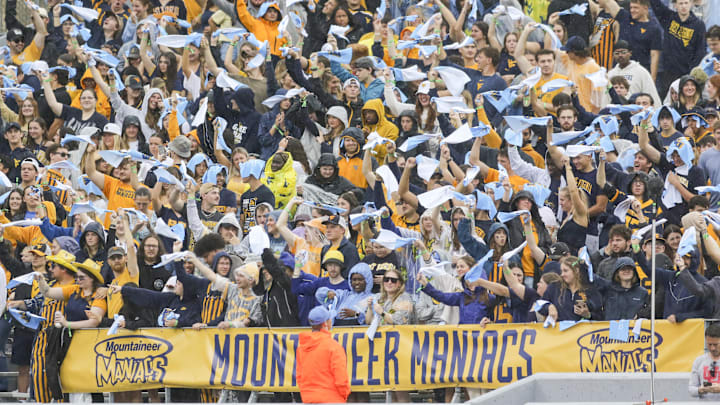 Sep 27, 2025; Morgantown, West Virginia, USA; West Virginia Mountaineers students cheer during the first quarter against the Utah Utes at Milan Puskar Stadium. Mandatory Credit: Ben Queen-Imagn Images Sep 27, 2025; Morgantown, West Virginia, USA; West Virginia Mountaineers students cheer during the first quarter against the Utah Utes at Milan Puskar Stadium. Mandatory Credit: Ben Queen-Imagn Images