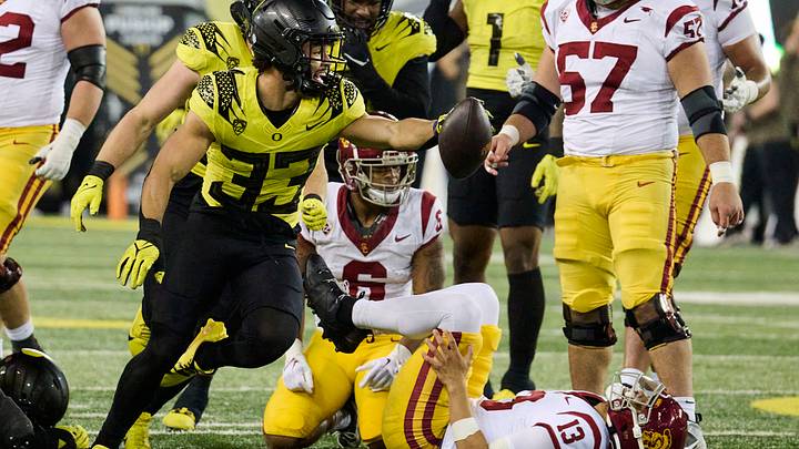 Nov 11, 2023; Eugene, Oregon, USA; Oregon Ducks defensive back Evan Williams (33) celebrates recovering a fumble during the second half against USC Trojans quarterback Caleb Williams (13) at Autzen Stadium. Mandatory Credit: Troy Wayrynen-USA TODAY Sports